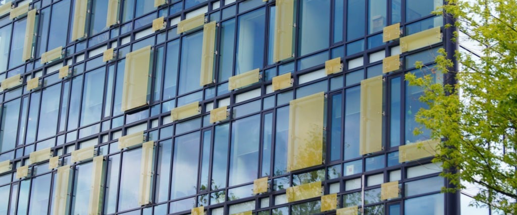 Building facade with squares of yellow glazing over a frame